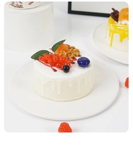 Close-up of realistic 10cm round mousse cake model with berries and cream texture