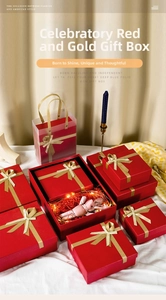 Detail of red gift boxes with golden ribbons, frosted bags and decorative fillers