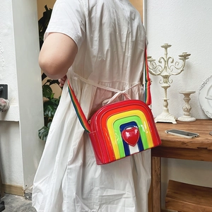 Detailed back view of rainbow crossbody bag with 3D heart and adjustable woven strap