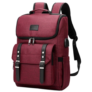 Detailed side view of burgundy oxford backpack showing integrated USB charging port