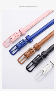 Detail of candy-colored glossy skinny belts with neat stitching and matching metal buckles