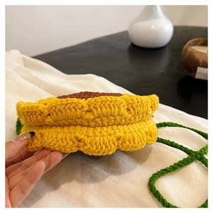 Detailed macro view of the thick hand-knitted sunflower texture on the yarn crossbody bag