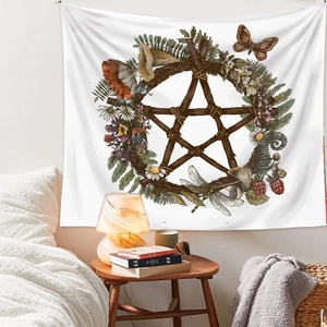 Detail view of a bohemian witchcraft mystery tapestry with floral pentagram on bedroom wall
