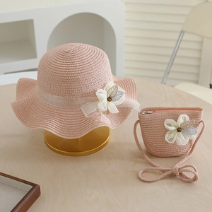 Pink woven straw hat and matching bag set with delicate white lace flower decorations