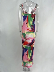 Detail of artistic abstract floral print and fine pleated texture on backless maxi dress