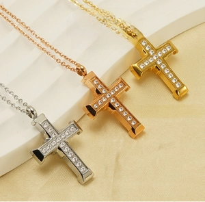 Macro detail of three-color 18K gold stainless steel cross necklaces with zircon inlays