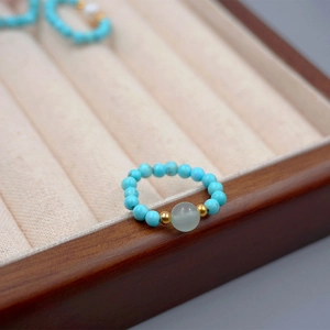 Handmade turquoise and freshwater pearl elastic beaded ring with golden spacer beads
