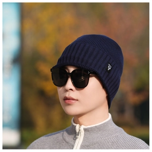 Close-up of navy knit beanie featuring ribbed texture and stylish logo tag on side