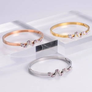 Three-tone snake shaped bracelets in rose gold, gold, and silver with crystal pavé
