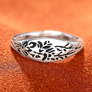 Vintage silver wide ring with engraved black floral patterns and oxidized finish