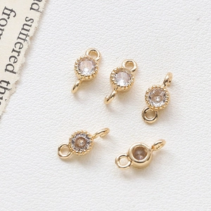 Macro detail of five gold-plated heart connectors with round cubic zirconia for DIY jewelry