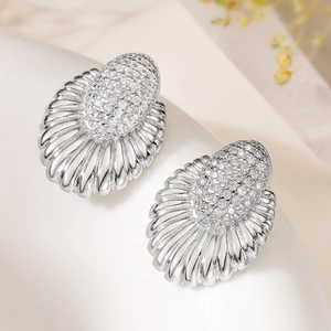 Silver oval shell zircon earrings with 18k gold plating and radial metal texture