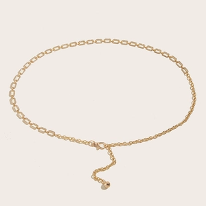 Detail of gold rhinestone metal chain belt with adjustable lobster clasp and ball charm