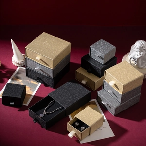 Detailed view of glitter jewelry gift boxes in gold, silver, and black drawer designs