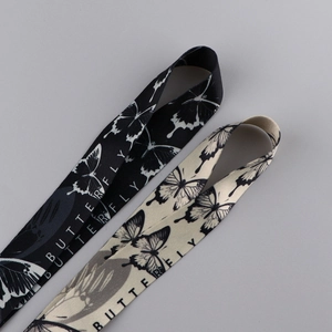 Detailed view of butterfly printed polyester lanyards in black and beige finishes
