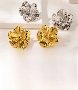 Detail of vintage 3D flower stud earrings in gold and silver finish titanium steel