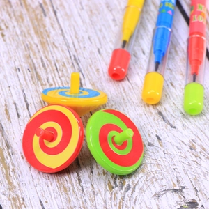 Detail of colorful children stationery set with three spinning tops and marker pens