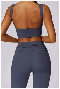 Rear view of deep blue-grey yoga set with open-back sports bra and high-waisted leggings