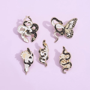 Set of 5 vintage snake and moon enamel pins in black, white, and gold metal finish
