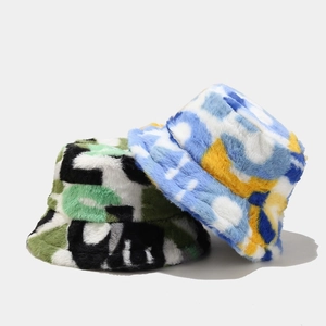 Detail of plush faux fur bucket hats showing camouflage and abstract patterns