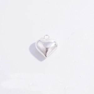 Detailed macro view of a polished S925 sterling silver heart-shaped pendant for DIY jewelry