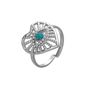 Detailed macro view of heart-shaped evil eye ring with blue crystal and silver finish