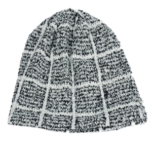 Close-up of black and white checkered knit beanie showing thick texture and wool blend fabric