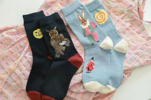 Detail of cotton crew socks featuring mismatched owl, moon, clown, and rabbit patterns