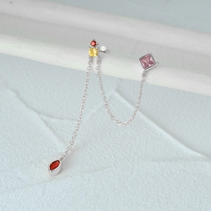 Macro shot of S925 sterling silver long chain earrings with colorful zircon gemstones