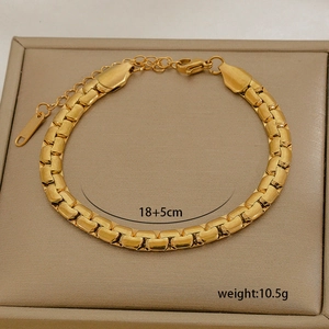 Detailed macro view of 18K gold plated titanium steel chain bracelet on jewelry box