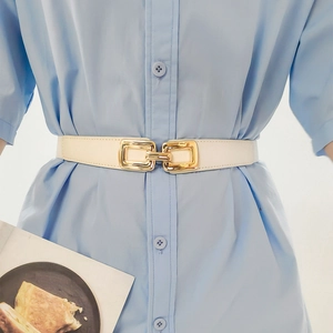 Elegant white elastic waist belt for women with a gold rectangular interlocking buckle