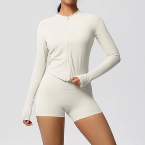Detail view of cream yoga set with zip jacket, thumbhole cuffs and high waist shorts