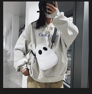 Funny ghost-shaped white crossbody bag with black eyes and nylon strap on model