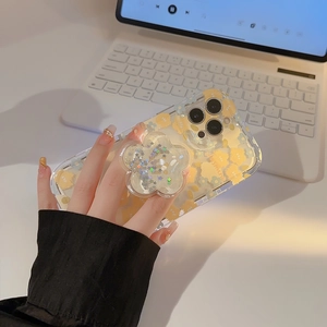 Detailed view of transparent floral iPhone case featuring a glittery flower pop socket