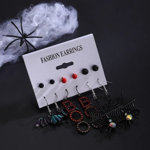Gothic Halloween earring set featuring spider web, bats, and BOO letters on black background