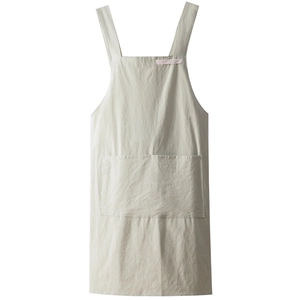 Linen cotton apron in beige with wide straps and a large front pocket on white background