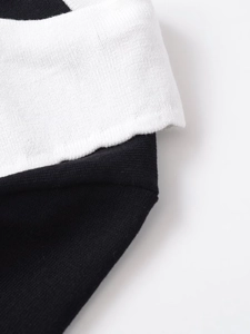 Close-up of the black and white contrast knit fabric texture on the bow lapel t-shirt