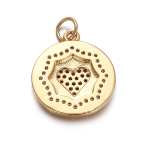 Detailed view of a gold heart pendant with dark stones and sparkling crystal halo