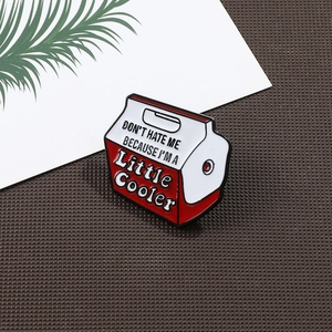 Detail of red and white cooler milk box enamel pin with funny text on brown surface