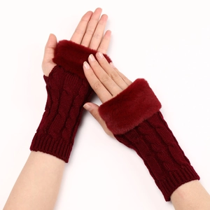 Detailed texture of burgundy cable knit arm warmers with faux fur trim on cuffs