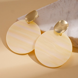Detail of geometric acrylic earrings with pleated texture and golden metal studs