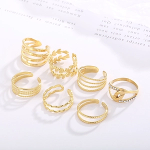 Minimalist 7-piece golden leaf ring set featuring adjustable open bands and crystals