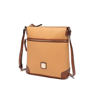 Close-up of pebble leather crossbody bag with dark brown piping and gold hardware
