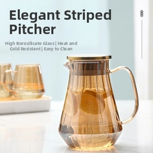 Detailed view of amber striped glass pitcher with gold handle and lid for cold beverages