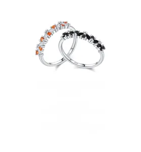 Detail of S925 sterling silver rings with orange, white, and black zircon stones