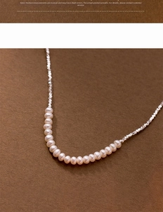 Macro detail of S925 silver necklace featuring small freshwater pearls and irregular silver beads