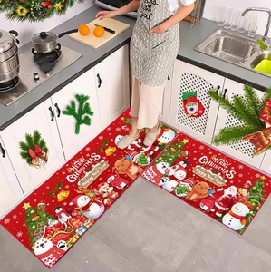 Detail view of two-piece Christmas kitchen mats with Santa Claus and reindeer illustrations