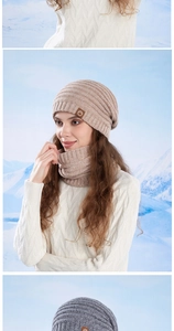 Detail of warm khaki knitted beanie and scarf set featuring thick ribbed texture and leather logo