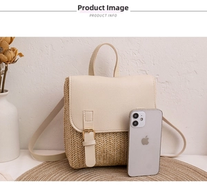 Detail showing mini woven backpack with faux leather flap next to a phone for size reference