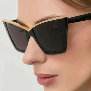 Fashionable oversized cat-eye sunglasses for women with black frames and gold metal trim